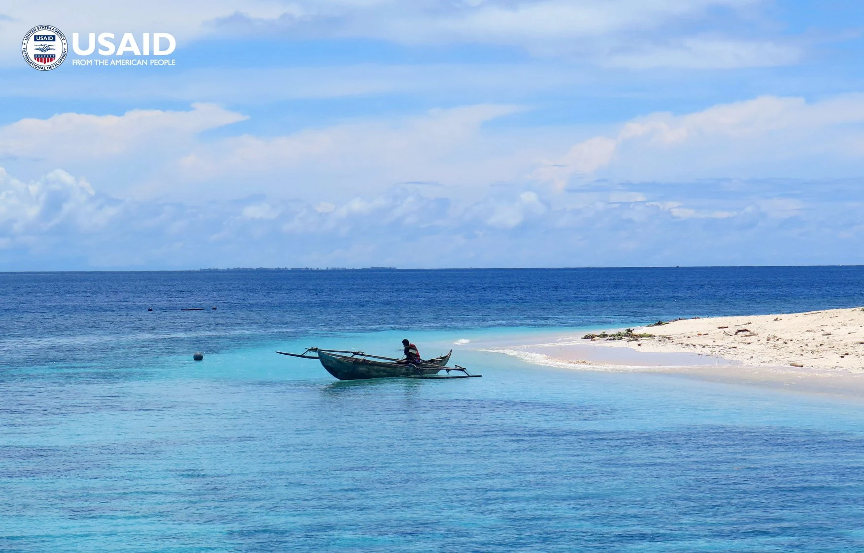 Clear water and a small boat beside the coast of Morotai