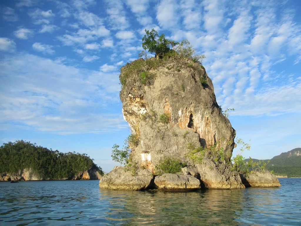 A limestone formation rising above the water in Triton Bay