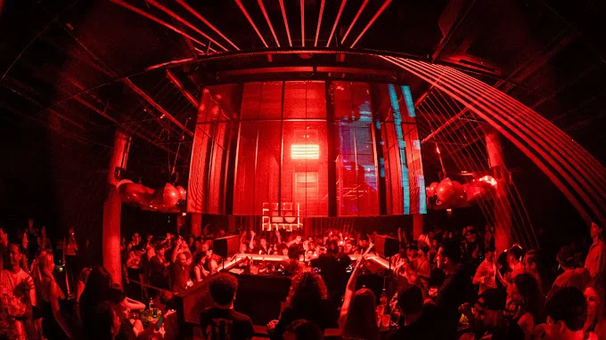 An evening venue with red architectural lighting