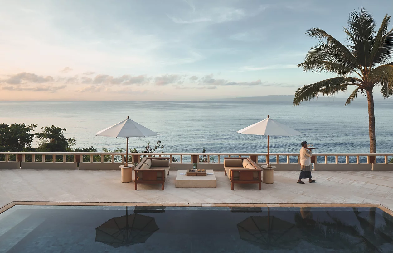 A quiet ocean-facing terrace with loungers and parasols