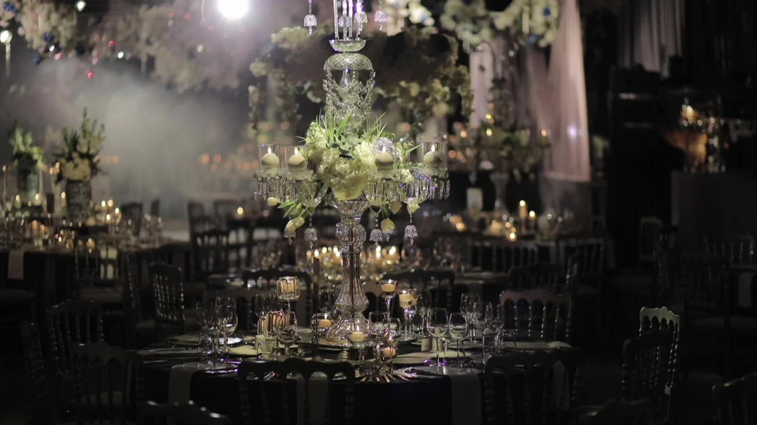 A formal celebration setting with glassware and candlelight