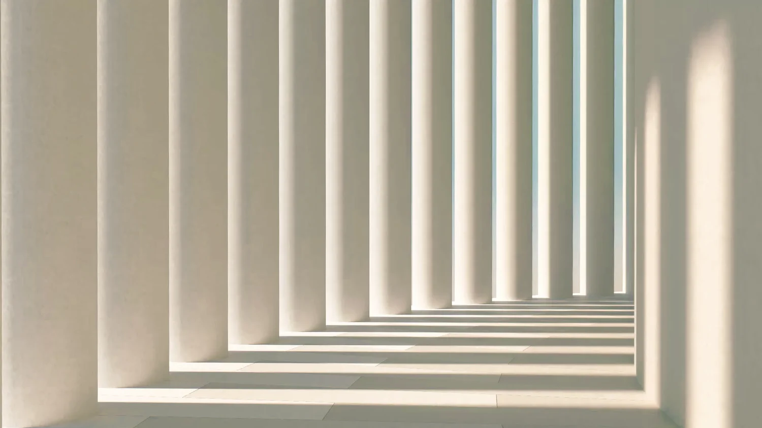 Light-filled architectural passage with sculptural columns