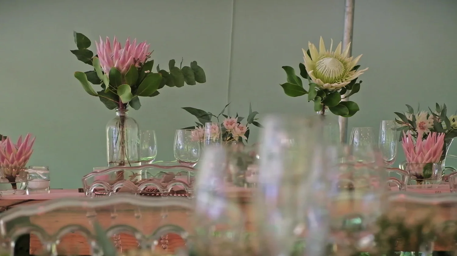 Flowers and glassware arranged for an intimate private dinner
