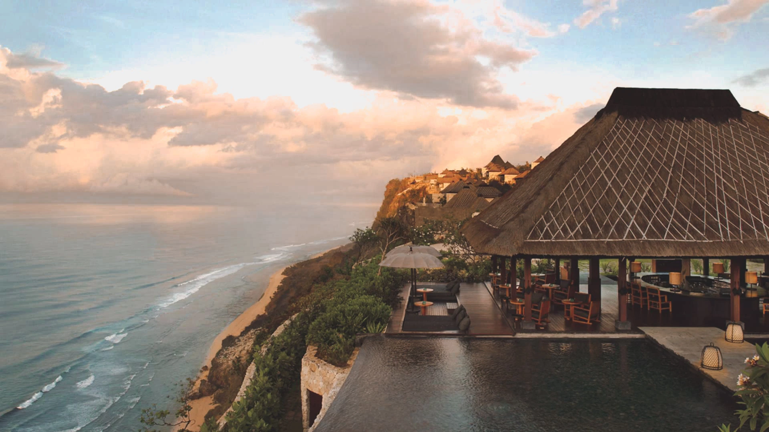 A cliffside retreat above the Bali coastline at sunset