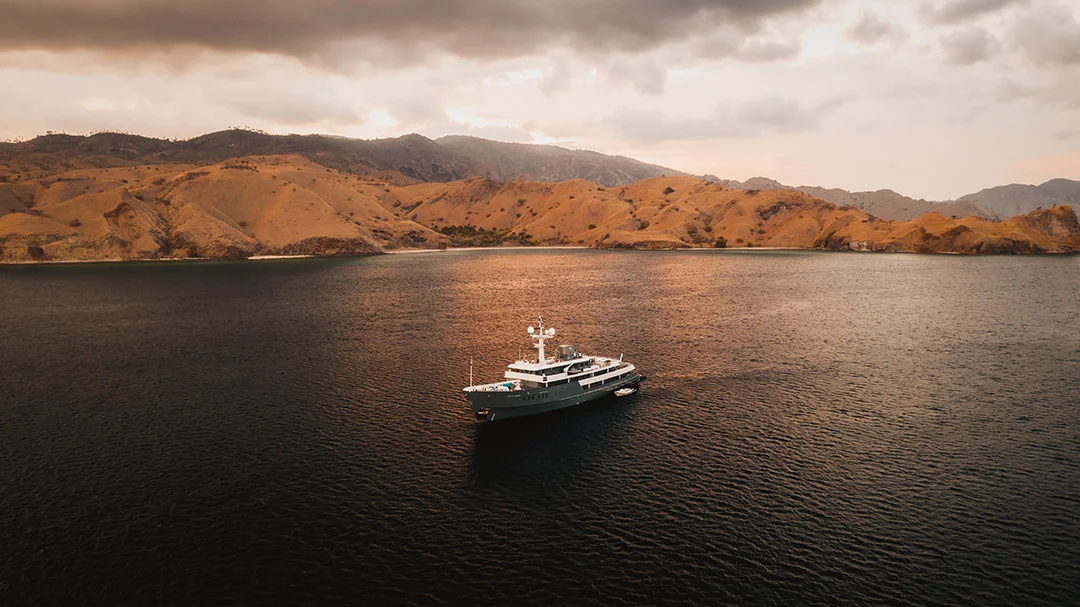A yacht at anchor beside an Indonesian island